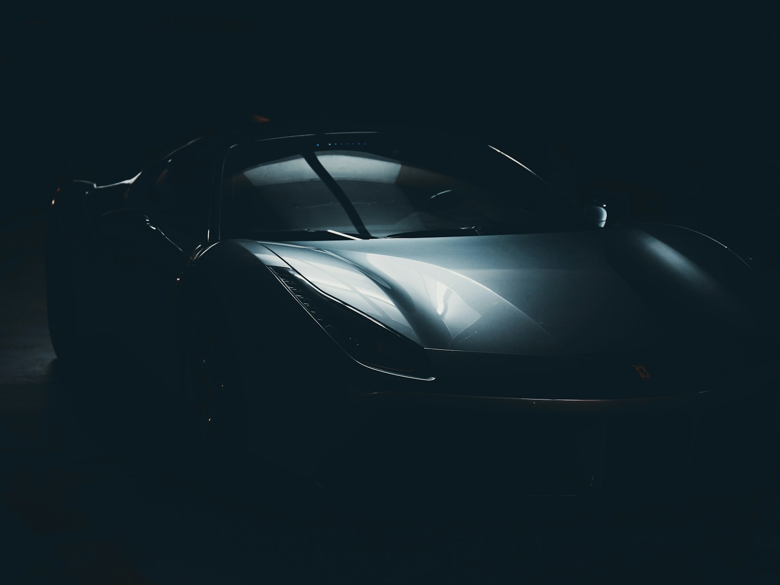Black sports car in dark studio